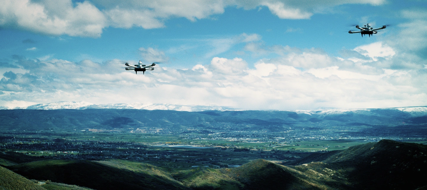 A cloud-seeding drone in the sky over a city